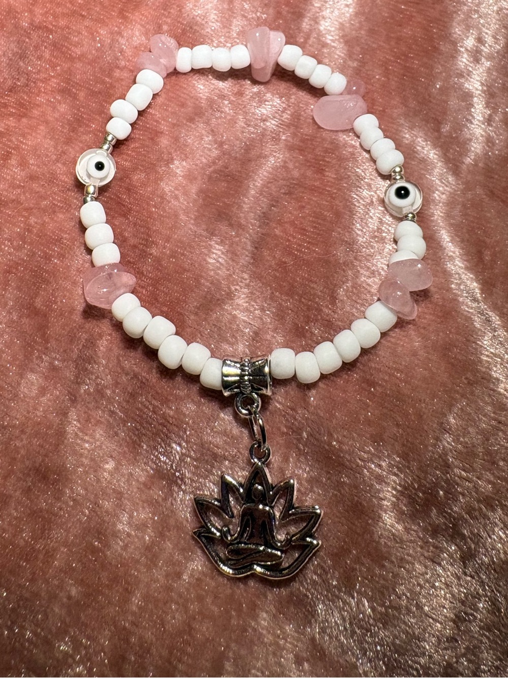 White beaded bracelet with Pink Rose Quartz crystals and a silver lotus charm.